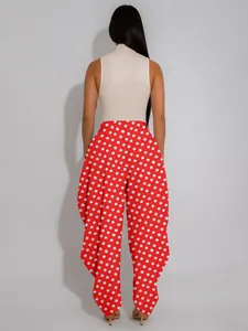 Back view of red polka dot high-waisted balloon pants with stylish draped wide-leg fit