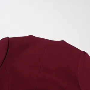 Detailed macro view showing the elegant round neckline and premium wine red fabric texture