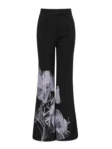 Elegant black high-waisted flare trousers with sophisticated white floral print detail