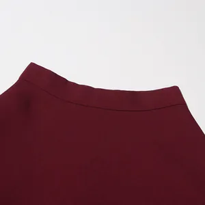 Detailed close-up showing the high waistline and fine texture of a vintage burgundy skirt