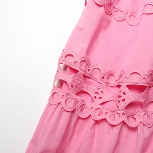Close-up detail of the exquisite hollow-out eyelet lace on a pink French retro dress