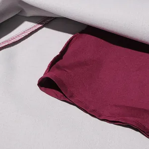 Macro view showing the contrast of burgundy lining and white outer fabric of a retro dress