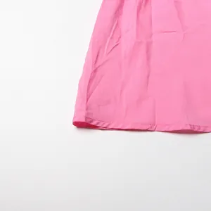 Detail showing the hemline and fabric texture of a pink French vintage dress.