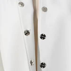 Close-up view showing silver metal snap buttons on an elegant white textured jacket