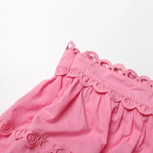 Close-up of elegant pink scalloped lace trim and hidden zipper on a vintage style dress.