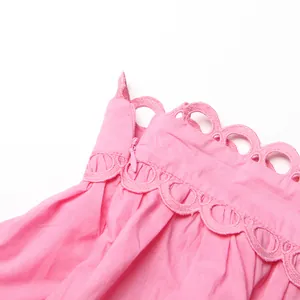 Detail shot showing the intricate pink scalloped lace and invisible zipper of a retro dress