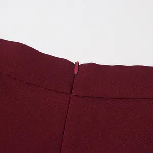 Detailed close-up showing the invisible zipper on a vintage burgundy high-waisted skirt