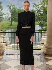 Elegant black two-piece set with beaded cropped top and high-waisted pencil skirt