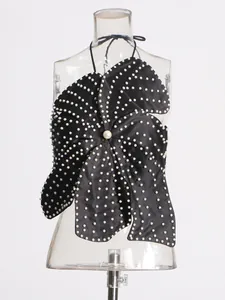 Elegant black floral-shaped halter top with heavy pearl embellishments on a mannequin