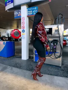 Stylish burgundy shiny leather cropped jacket with matching thigh-high stiletto boots