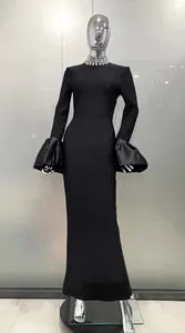 Detail view of black evening dress featuring a rhinestone collar and satin flare cuffs.