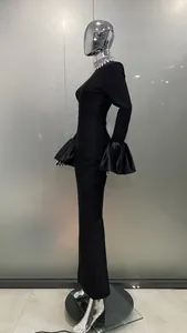 Side view of elegant black bandage dress with rhinestone collar and flared sleeves