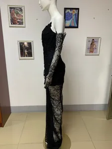 Side view of elegant black lace evening gown with intricate beaded detail and sleeves
