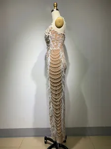 Side view detail of white sequin embroidery evening gown with pearls and feathers