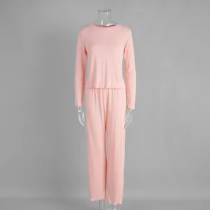 Two-piece pink long-sleeved pajama set with heart jacquard texture on clear mannequin