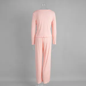Back view of pink knitted long-sleeved pajama set showing ribbed texture and ruffled hem
