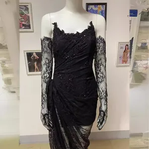Elegant black lace evening gown with intricate beaded detail and matching lace gloves.