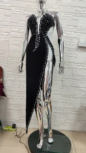 Close-up detail of black velvet evening gown with luxury rhinestone beadwork and side slit
