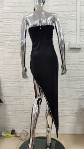 Back view of a black velvet formal dress with sparkling sequin details and a high slit