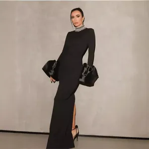 Elegant black evening gown featuring a rhinestone collar and dramatic puffy bell sleeves