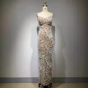 Luxurious floor-length white sequin evening gown with pearl beads and feather trim
