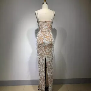 Elegant white sequined maxi evening dress with embroidery and feather trim detail