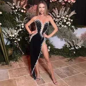 Elegant black velvet evening dress featuring heavy luxury beadwork and sexy high slit design