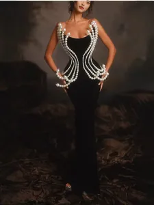 Elegant black velvet maxi dress with sculptural pearl beaded embellishments throughout.