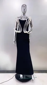 Elegant black strapless evening gown featuring intricate sculptural pearl bead draping.