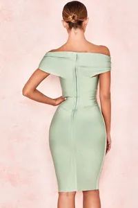 Back view of a light green off-the-shoulder bandage dress showing the zipper detail