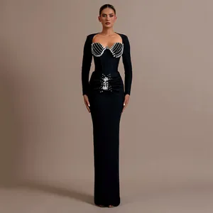 Detail of elegant black bandage evening dress with sparkling diamond embellishments.