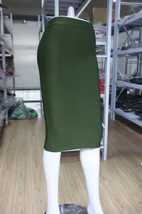 Close-up detail of an olive green knee-length bandage skirt on a display mannequin