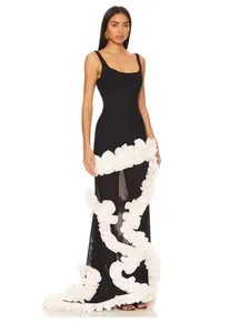 Full-length detail view of a black slim fit maxi dress featuring white cascading ruffle flowers
