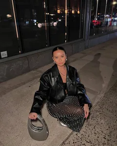 Sexy sheer bodycon skirt with sparkling rhinestones worn with a leather jacket