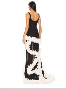 Exquisite back view of a black evening gown with ornate white ruffled floral trim.