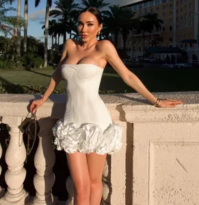 Elegant white strapless bodycon corset dress featuring a ruffled floral textured skirt.