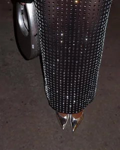 Close-up detail of sexy black sheer bodycon skirt with sparkling square rhinestones