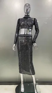 Detailed view of a sparkling square rhinestone mesh long-sleeve top and midi skirt on a mannequin.