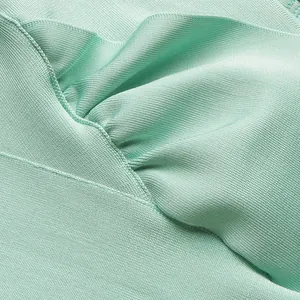 Macro detail of mint green bandage dress showing high-quality stitching and fabric texture