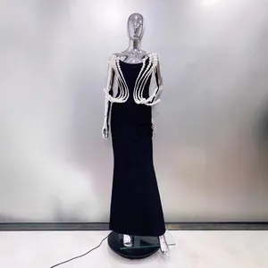 Elegant black strapless floor-length evening gown with intricate pearl bead shoulder details.