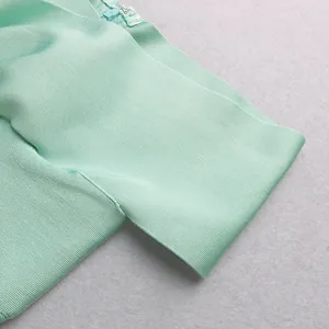 Detailed view of mint green bandage dress showing high-quality ribbed fabric and zipper.