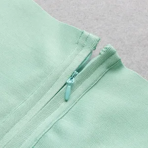 Macro close-up showing the invisible zipper detail on a mint green bandage dress fabric