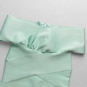 Close-up of mint green off-shoulder bandage dress showing fabric texture and zipper