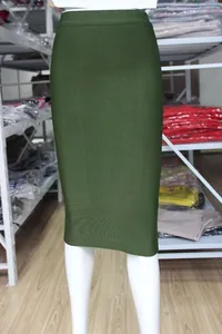 Close-up detail of a dark green elastic bodycon bandage midi skirt on a white mannequin