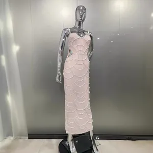 Elegante abito da sera pesantemente decorato con perle e motivi a conchiglia per party.