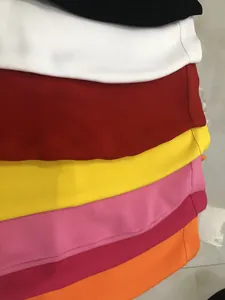 Close-up detail showing a variety of colorful bandage skirts in elastic ribbed fabric.