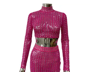 Close-up of hot pink two-piece set with square rhinestones and sheer mesh fabric.