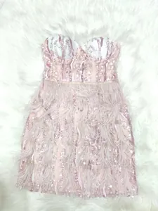 Close-up detail of a pink strapless sequin bandage evening dress featuring elegant feather trim