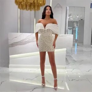 Elegant white beaded off-the-shoulder mini dress with luxury pearl ruffle detailing