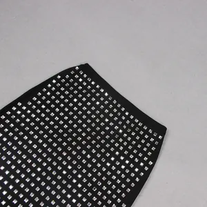 Close-up of sparkling square rhinestones on a sexy black sheer mesh bodycon mini skirt.